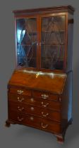 A George III mahogany bureau bookcase, the moulded cornice above two astragal glazed doors, the