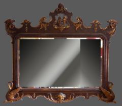 A 19th Century French large wall mirror, the pierced and gilded top with central carved figure of