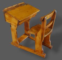 A Victorian pine and elm child's school desk and chair by Geo. M. Hammer & Co, The Strand, London,