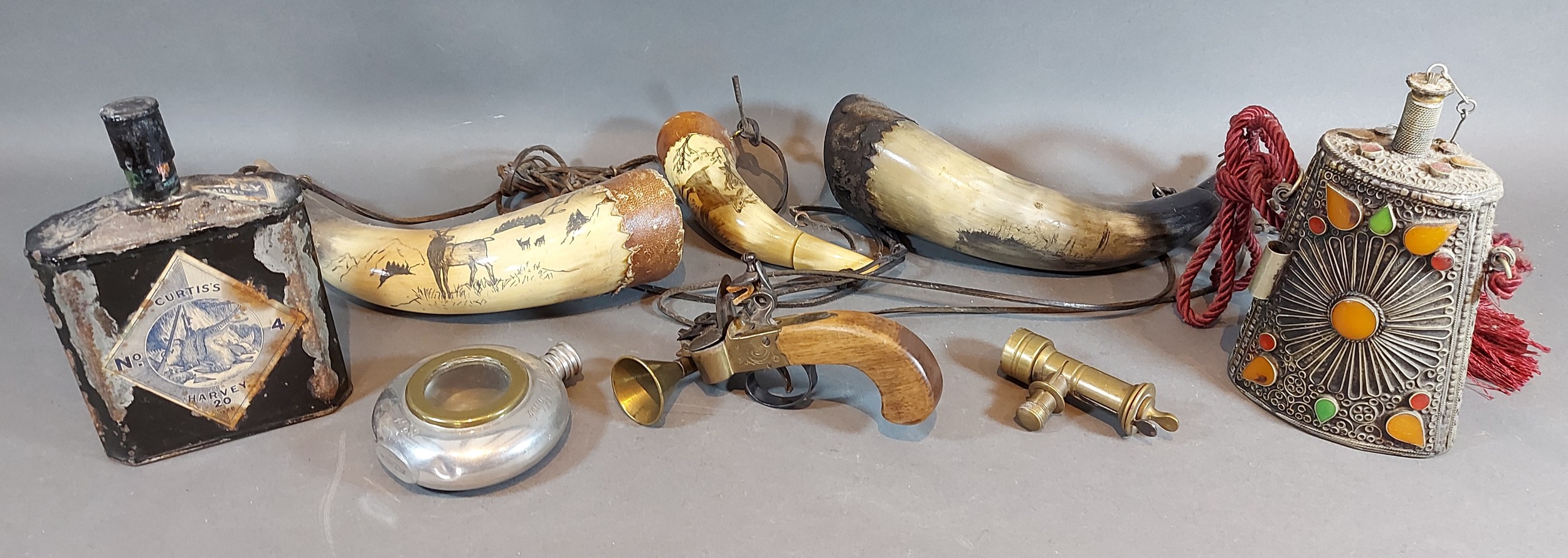 A Flintlock Tinderbox together with four powder flasks and other related items