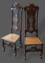 A pair of 19th Century oak Jacobean style side chairs, each with a carved cane back above a