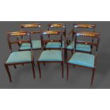 A set of six carved rail back dining chairs, together with a twin pillar extending D end dining