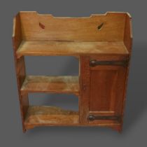 An Arts and Crafts oak handing wall cabinet, together with an oak hanging corner cabinet, a carved