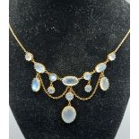 A 9ct gold garland necklace set with cabochon moonstone drops upon a fine linked chain, 43cms