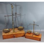 A set of brass and steel balance scales marked Avery with mahogany box base together with a