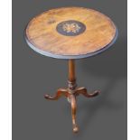A Victorian marquetry inlaid pedestal table, the circular top upon an turned column and three shaped