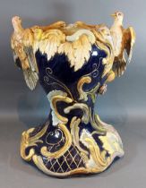 A Majolica jardinier with bird surmount decorated in polychrome enamels, 44cms tall