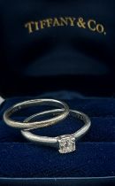 A Tiffany and Co. Lucida Platinum solitaire Diamond ring, 0.32ct, ring size J, 3.6gms together