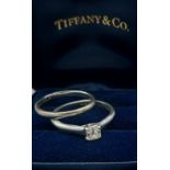 A Tiffany and Co. Lucida Platinum solitaire Diamond ring, 0.32ct, ring size J, 3.6gms together