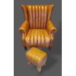 A tan leather upholstered wing back armchair raised upon square tapered legs together with a similar