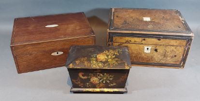 A Victorian black lacquered tea caddy decorated with flowers together with two work boxes