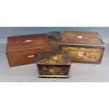 A Victorian black lacquered tea caddy decorated with flowers together with two work boxes