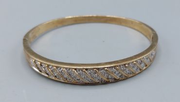 A 9ct gold bangle set with Diamonds, 14.9gms