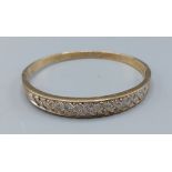 A 9ct gold bangle set with Diamonds, 14.9gms