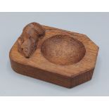 A Robert Mouseman Thompson oak pin tray, decorated with a carved mouse, 10cms long