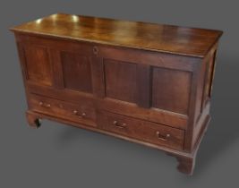 A George III oak mule chest, the hinged top above two drawers raised upon bracket feet, 136cms wide,