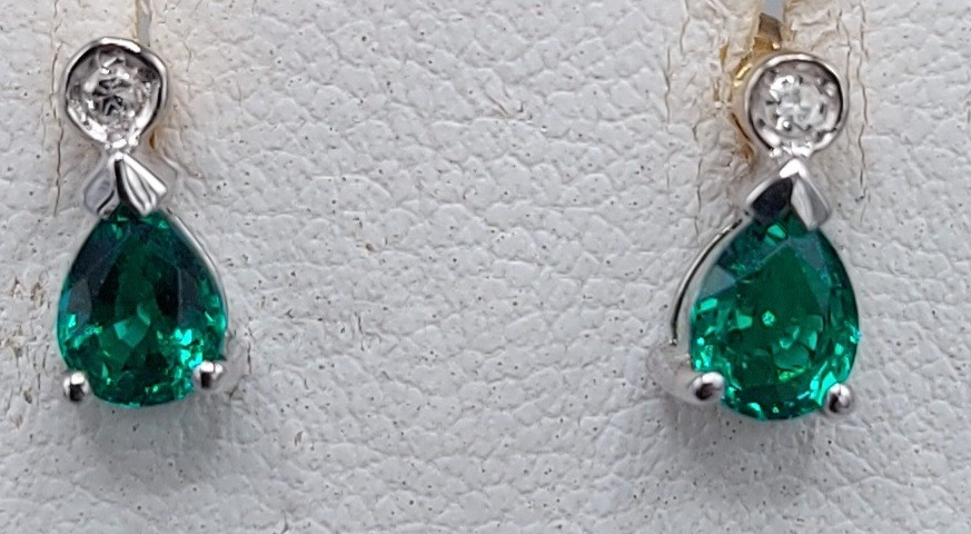 A pair of 9ct gold diamond and emerald set ear studs of tear drop form