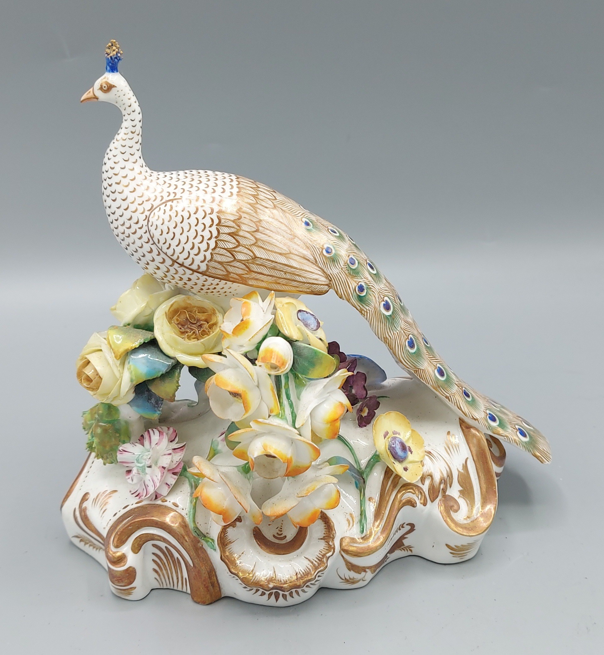 A 19th Century possibly Derby porcelain model in the form of a Peacock with foliate encrusted - Image 2 of 3