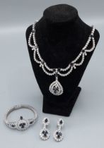 An 18ct white gold, Diamond and Sapphire suite of jewellery comprising a necklace set with two