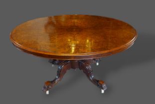 A Victorian burr walnut centre table, the moulded top above a carved column support with four