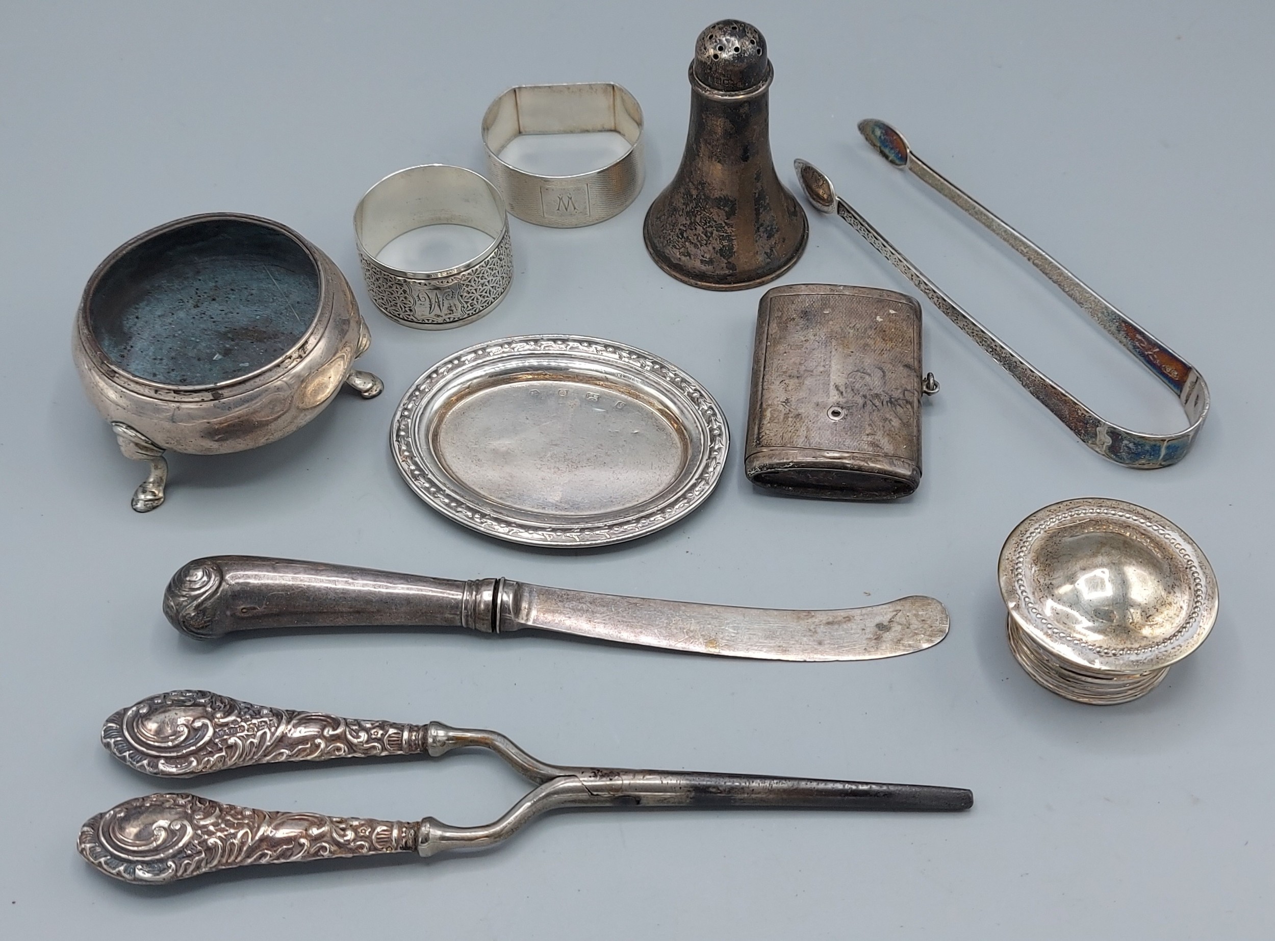 A silver salt together with a pair of Georgian silver sugar tongs and other items to include two