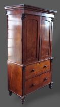 A William IV mahogany press cupboard, the moulded cornice above two panel doors enclosing shelves,