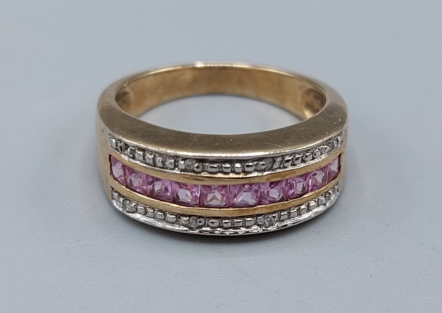 A 9ct gold dress ring set with Diamonds and pink stone, 3.4gms, ring size L