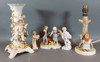 A German porcelain lamp base decorated with putti, together with a Goebels lamp and three