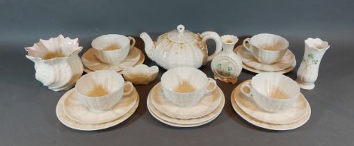 A collection of Belleek to include a teapot, cups and saucers and three vases