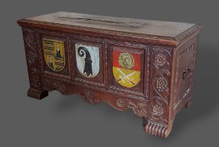 A 19th Century Continental small chest, the hinged top above a carved front with three painted