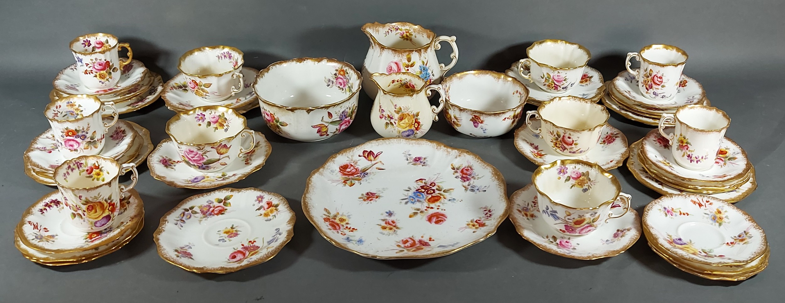 A Hammersley tea and coffee service comprising cups, saucers and plates, all hand painted with