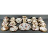 A Hammersley tea and coffee service comprising cups, saucers and plates, all hand painted with