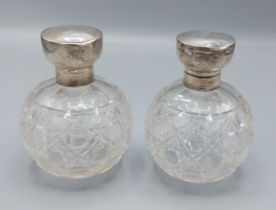 A pair of Birmingham silver mounted perfume bottles of globular form, 11.5cms tall
