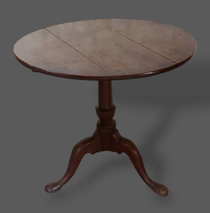 A George III oak pedestal table, the circular top above a turned centre column with pad feet,
