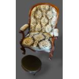 A Victorian mahogany drawing room armchair with a button upholstered back above an overstuffed