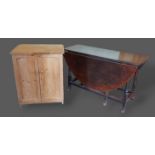 A George III oak gate leg dining table together with a pine small cupboard