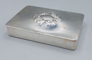 A Sterling silver box by Georg Jensen, the hinged cover with central foliate embossing, 10ozs, 14cms