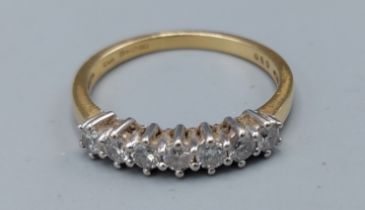 An 18ct yellow gold ring set with seven diamonds with in a pierced setting, approximately 0.50ct,