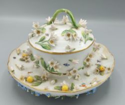 A Meissen porcelain covered bowl on stand with foliate encrusted decoration and highlighted with