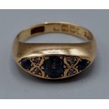 An 18ct gold ring set with three Sapphire and four small Diamonds, 4.3gms, ring size J