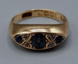 An 18ct gold ring set with three Sapphire and four small Diamonds, 4.3gms, ring size J