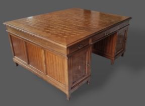 An Edwardian mahogany and inlaid twin pedestal partners desk, the cube pattern inlaid and moulded