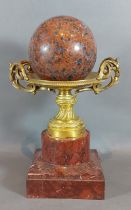 A French gilt metal comport upon square rouge marble base together with a rouge marble ball, 28cms