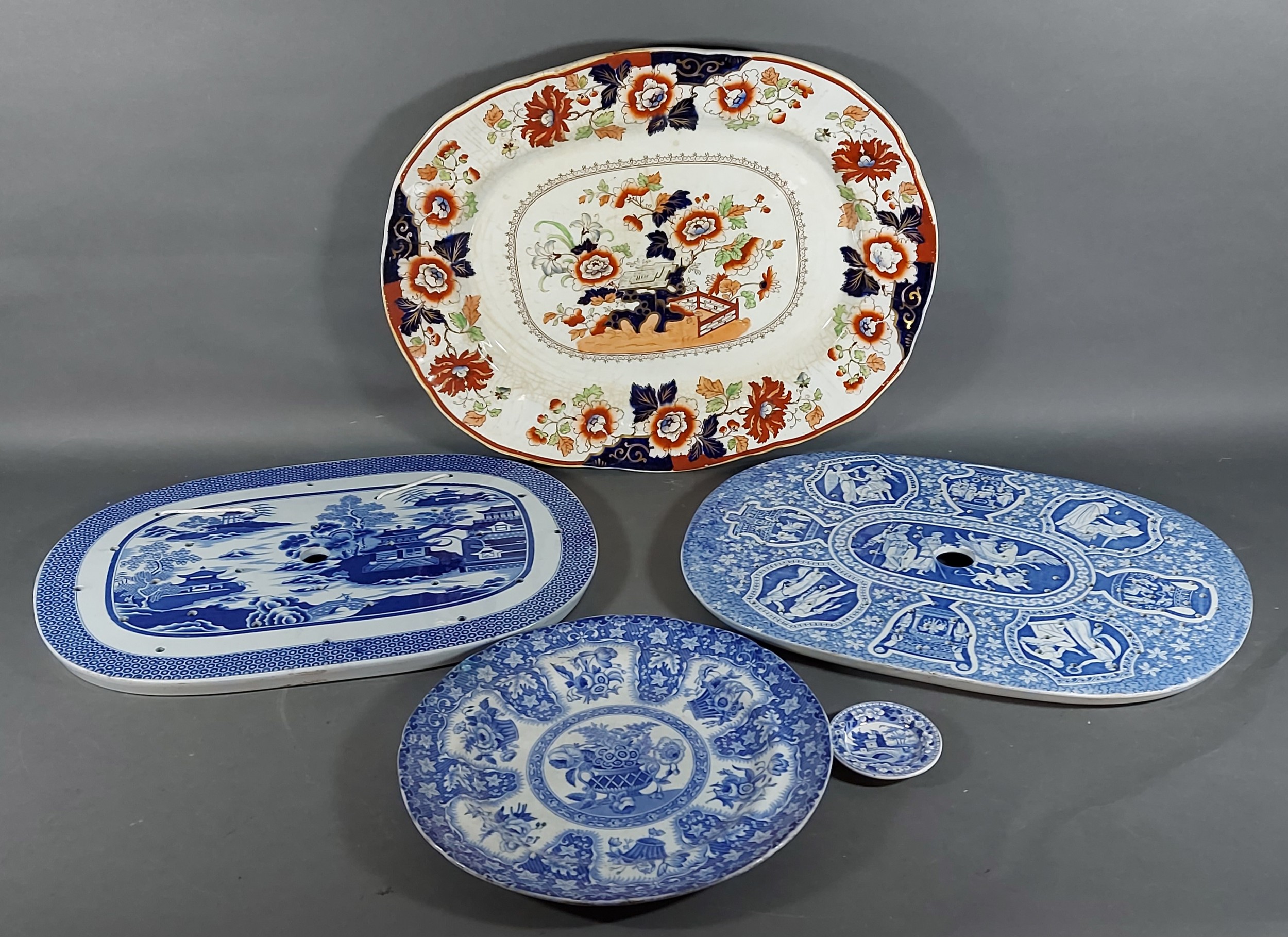 Two 19th Century blue and white decorated strainers together with a meat platter, a 19th Century