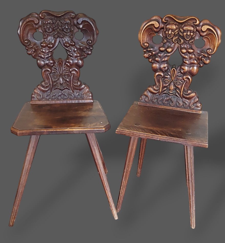 A near pair of 19th Century Italian hall chairs, each with a carved back above a panel set raised