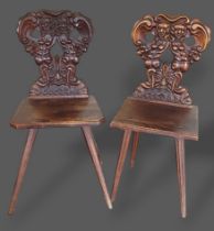 A near pair of 19th Century Italian hall chairs, each with a carved back above a panel set raised