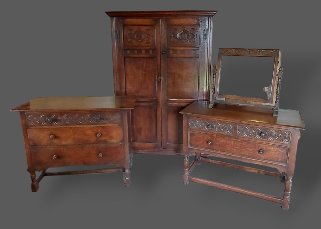 An 18th Century style oak bedroom suite comprising two door wardrobe, a matching three drawer