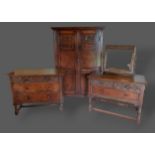 An 18th Century style oak bedroom suite comprising two door wardrobe, a matching three drawer