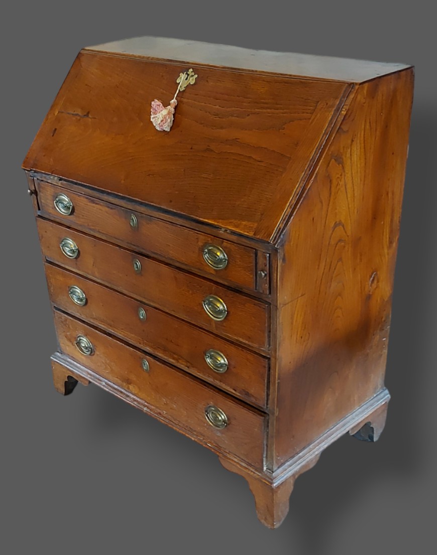 A George III elm bureau, the fall front above four long graduated drawers with oval brass handles