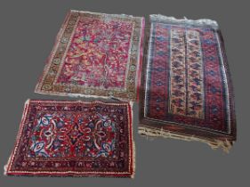 A North West Persian woollen rug together with two other similar rugs